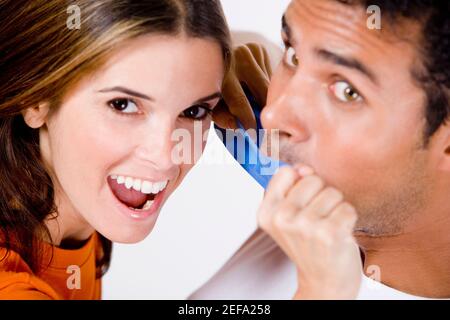Portrait of a mid adult woman sticking an adhesive tape on a young manÅ½s mouth Stock Photo