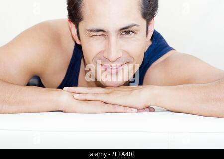 Portrait of a young man winking his eyes and smiling Stock Photo