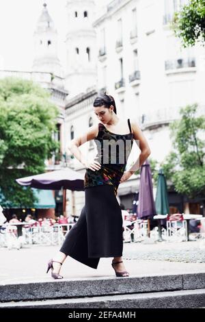 Young woman dancing on the sidewalk Stock Photo