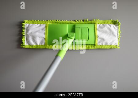 Plastic mop with green microfiber cloth closeup Stock Photo
