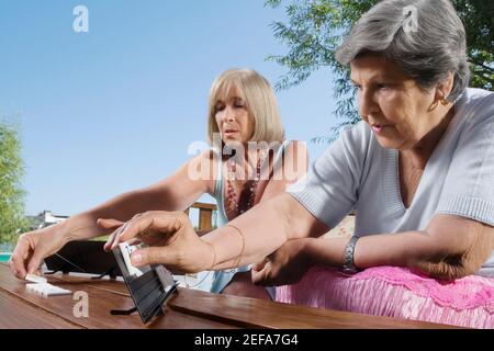 Two women playing mahjong Stock Photo