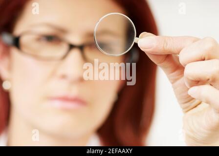Close-up of a female optometrist holding a lens Stock Photo