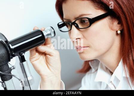 Close-up of a female optometrist using a phoropter Stock Photo