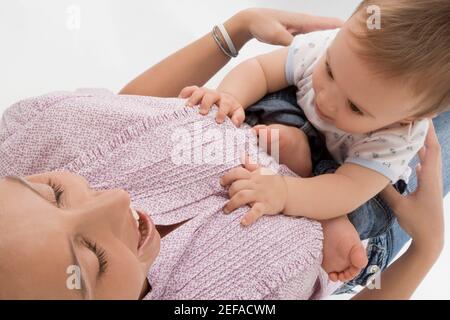 Close up of a mid adult woman playing with her son Stock Photo