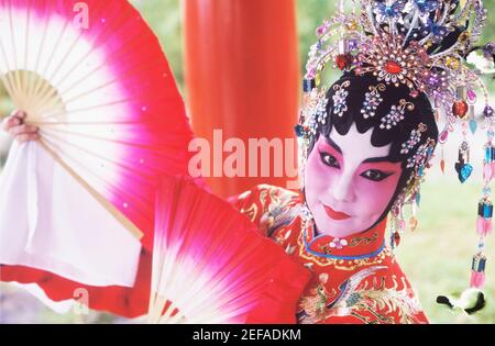 Portrait of a female Chinese opera performer holding folding fans, Singapore Stock Photo