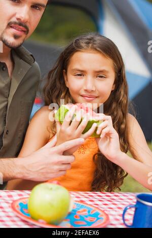 Close-up of a father and his daughter holding a slice of watermelon Stock Photo
