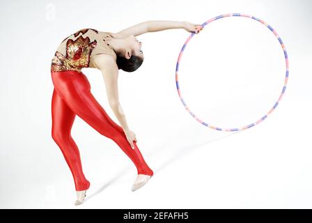 Woman, gymnastics and hoop for performance, sports training and dancing  action in arena. Female, rhythmic movement and dancer with spinning ring  for Stock Photo - Alamy