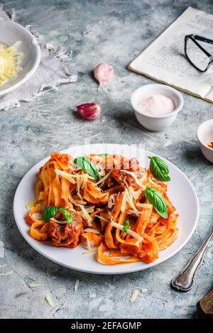 Pasta with mini meatballs, tomato sauce and parmesan cheese Stock Photo