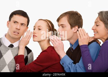 Business executives whispering to each other Stock Photo