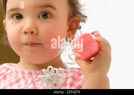 Portrait of a girl using a toy phone Stock Photo