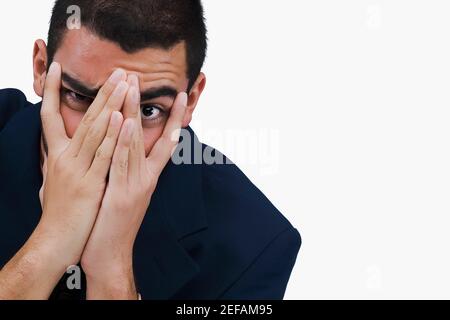 Portrait of a businessman covering his face with his hands Stock Photo