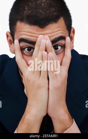 Portrait of a businessman covering his face with his hands Stock Photo