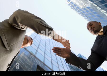Low angle view of two businessmen shaking hands Stock Photo