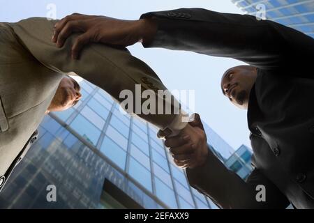 Low angle view of two businessmen shaking hands Stock Photo