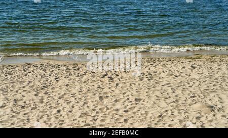 Small waves on the shore of the sea with beach and spray on the Baltic Sea Stock Photo
