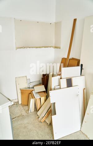 Old furniture waiting for bulky waste to be picked up in kitchen during a renovation Stock Photo