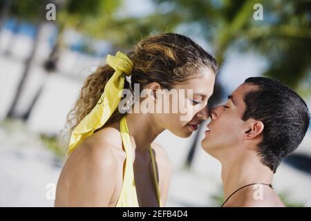 Close up of a mid adult man and a young woman kissing Stock Photo