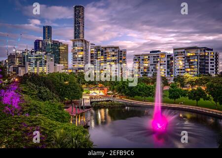 Residential apartment buildings around the Roma Street Parkland with illuminated fountain, Brisbane, Australia Stock Photo