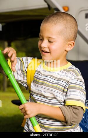 Close-up of a boy holding a butterfly net Stock Photo