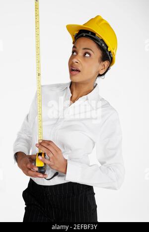 Close-up of a female architect holding a tape measure Stock Photo