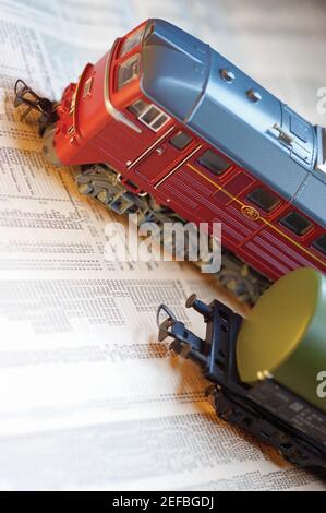 Toy train on top of stock report, close-up Stock Photo