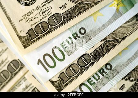 Euro 100 bank notes and United States one hundred dollar bills, close-up Stock Photo