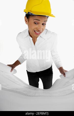 High angle view of a female architect holding a blueprint and making a face Stock Photo