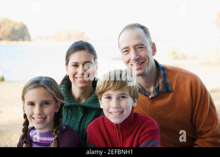 Portrait of a mid adult couple with their two children Stock Photo