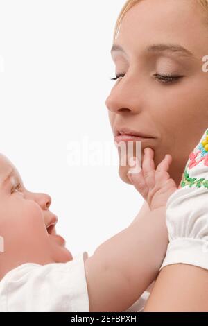 Close up of a mid adult woman smiling with her son Stock Photo