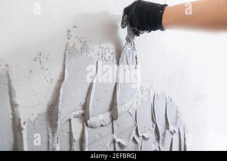 Plaster mortar for gray concrete wall on trowel. Stock Photo