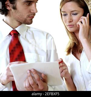 Businessman and a businesswoman discussing documents Stock Photo