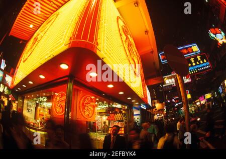Low angle view of a building lit up at night, Hong Kong, China Stock Photo