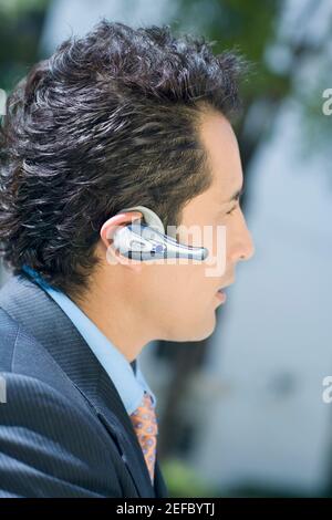 Close-up of a businessman wearing a hands free device Stock Photo
