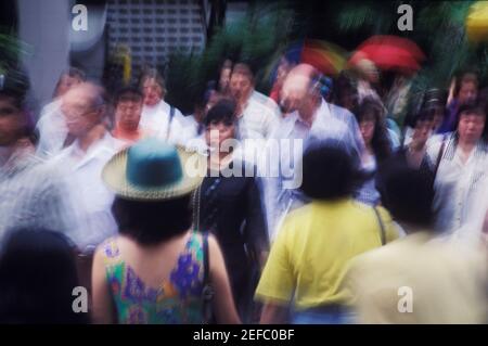 Group of people walking in a city, Singapore Stock Photo