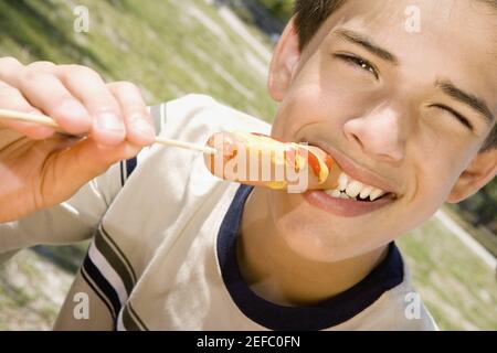 Portrait of a boy eating a sausage Stock Photo