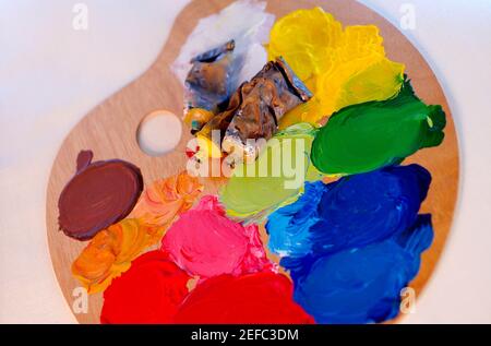 High angle view of three paint tubes on a palette Stock Photo