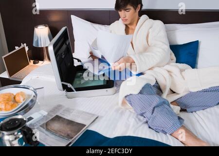 Young man examining documents Stock Photo