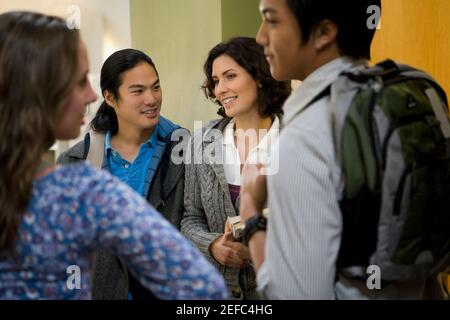University students talking in a corridor Stock Photo