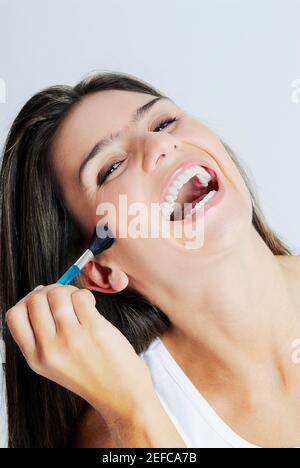 Portrait of a young woman applying make up Stock Photo