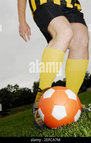 Low section view of a soccer player playing with a soccer ball Stock Photo