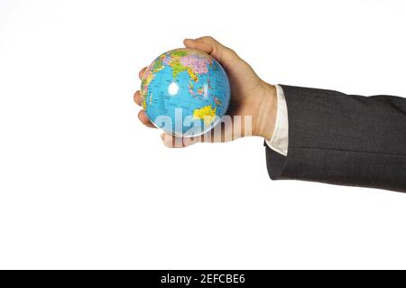 Close-up of a businessman holding a globe Stock Photo