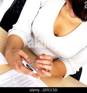 High angle view of a businesswoman using a personal data assistant Stock Photo