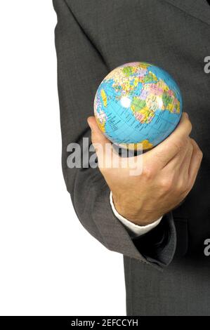 Mid section view of a businessman holding a globe Stock Photo