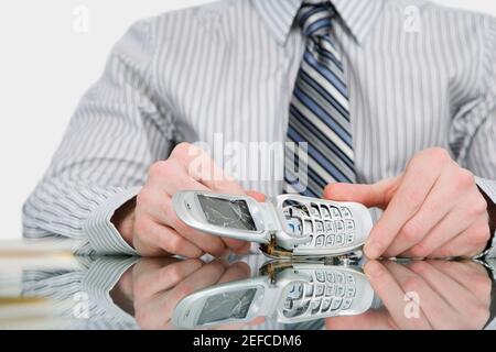 Close up of a businessman holding a broken mobile phone Stock Photo