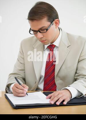 Businessman writing on a document Stock Photo