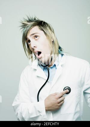 Close up of a male doctor examining himself with a stethoscope Stock Photo