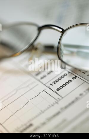 Close up of a pair of eyeglasses on a financial report Stock Photo
