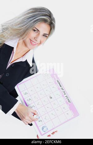 Close up of a businesswoman holding a progress report and smiling Stock Photo