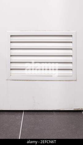 Closeup of the grille pattern on the white PVC door of the bathroom, for air vent, for ventilation while bathing in the bathroom, front view with the Stock Photo