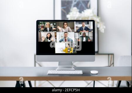 Online lesson, distance learning. On the computer screen is many different multiracial people and a teacher who conducts an online lecture for students using a video conference Stock Photo